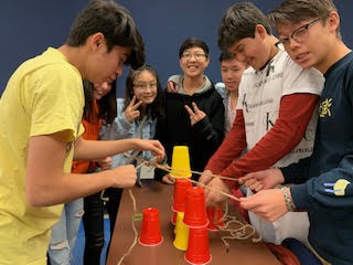 students playing climate action with cups game